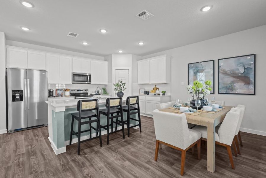 A kitchen with a dining table and chairs. A kitchen with a dining table and chairs.