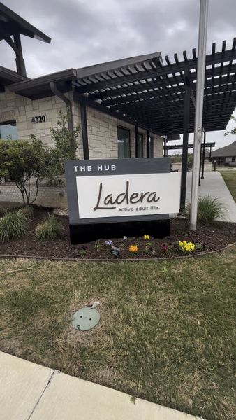 A modern community entrance with sleek stone facade and landscaped greenery in Ladera Prosper by Ladera Texas (Prosper, TX). A modern community entrance with sleek stone facade and landscaped greenery in Ladera Prosper by Ladera Texas (Prosper, TX).