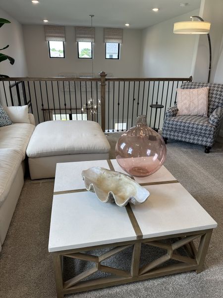 A cozy loft area with plush seating, modern decor, and large windows providing ample natural light. A cozy loft area with plush seating, modern decor, and large windows providing ample natural light.