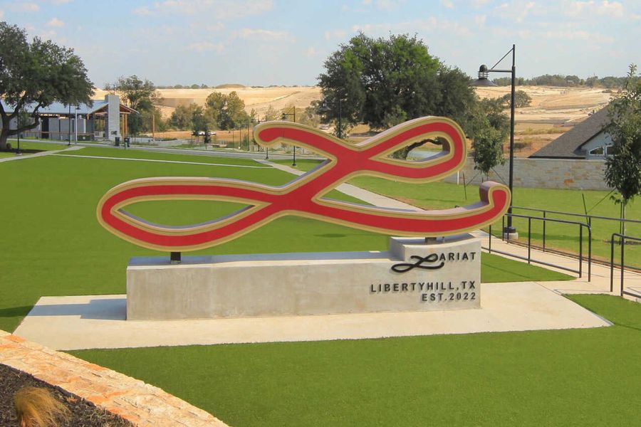 Entrance to the Lariat: 80ft. lots community in Liberty Hill, TX, featuring signage and landscaping (Image 1). Entrance to the Lariat: 80ft. lots community in Liberty Hill, TX, featuring signage and landscaping (Image 1).