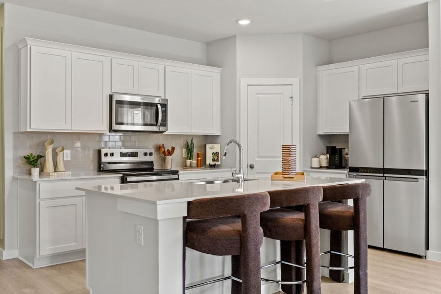 A kitchen with white cabinets. A kitchen with white cabinets.