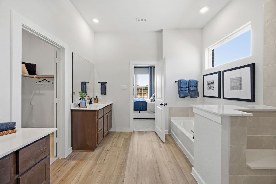 A bathroom with a tub sink and a toilet. A bathroom with a tub sink and a toilet.