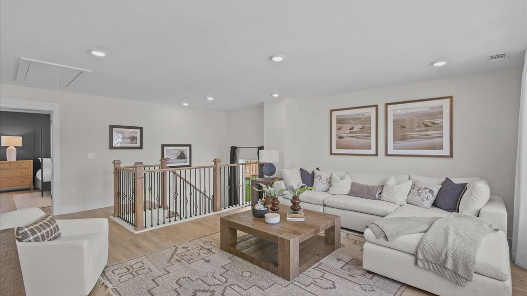 Spacious, cozy upstairs loft with hardwood flooring at Kayfield at Midway by DRB Homes in Anderson, SC