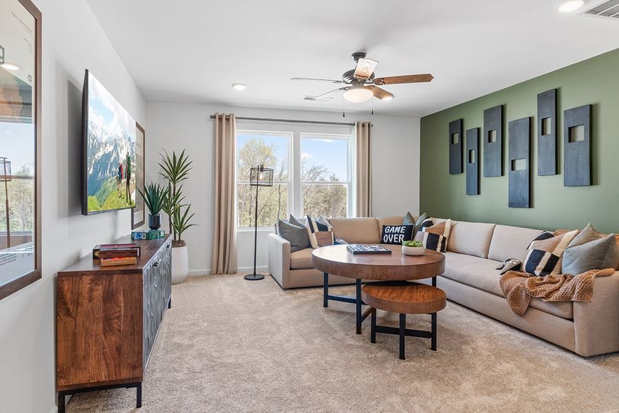 A living room with a couch and a table. A living room with a couch and a table.