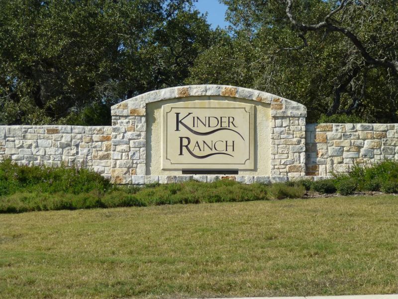 Entrance to the Kinder Ranch 70's community in San Antonio, TX, featuring signage and landscaping (Image 1).