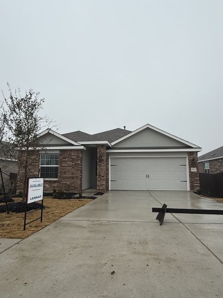 A charming brick home with a two-car garage in Lively Ranch: Claremont Collection by Lennar (Georgetown, TX).