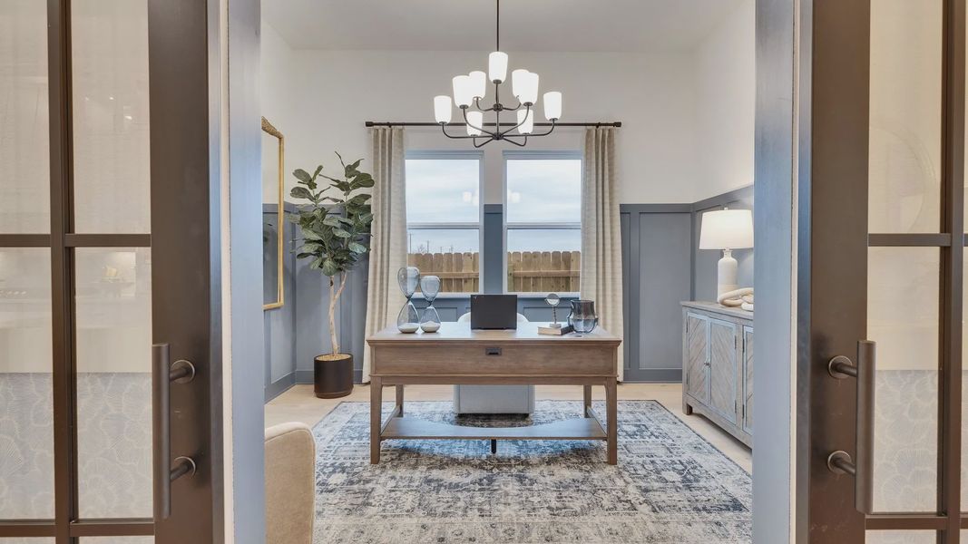 Exquisite home office with French doors, chic chandelier, and serene palette in Spring Creek, Texas.