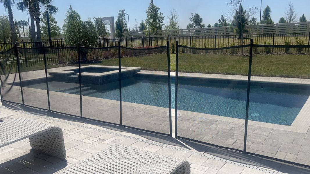 A serene backyard pool with a fenced area, surrounded by a landscaped garden. Perfect for relaxation and outdoor enjoyment. A serene backyard pool with a fenced area, surrounded by a landscaped garden. Perfect for relaxation and outdoor enjoyment.