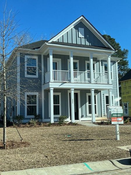 A charming two-story home with a welcoming porch in Pineland Village by Center Park Homes (Summerville, SC).
