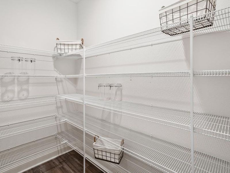 A walk-in pantry provides storage convenience - Waylyn model home in St. Cloud, FL
