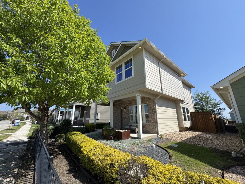 A charming two-story home with lush landscaping and a cozy porch in the Trace community by Pacesetter Homes (San Marcos, TX). A charming two-story home with lush landscaping and a cozy porch in the Trace community by Pacesetter Homes (San Marcos, TX).