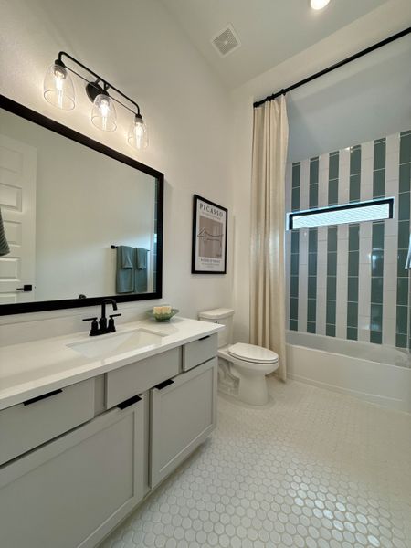 A modern bathroom with sleek cabinetry, patterned tiles, and stylish lighting for a contemporary touch. A modern bathroom with sleek cabinetry, patterned tiles, and stylish lighting for a contemporary touch.