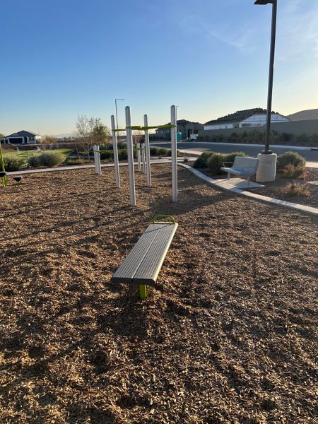 A modern park with a fitness area and benches in Copper Falls by D.R. Horton, Buckeye, AZ.