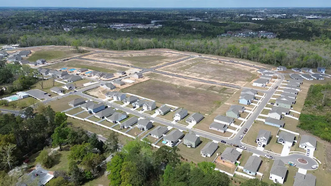 Aerial view of the The Bluffs at Mill Creek community in Florence, SC, showing layout and nearby surroundings (Image 1). Aerial view of the The Bluffs at Mill Creek community in Florence, SC, showing layout and nearby surroundings (Image 1).