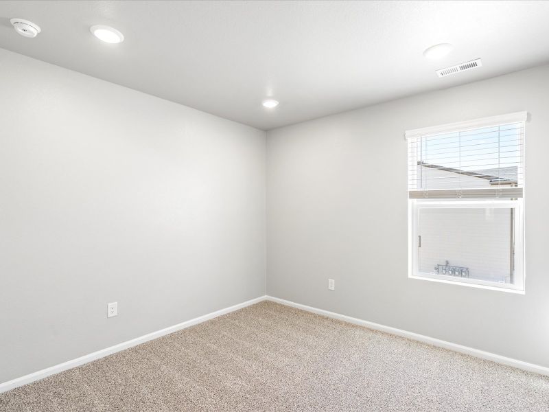 Bedroom in the Woodland floorplan at a Meritage Homes community in Broomfield, CO.