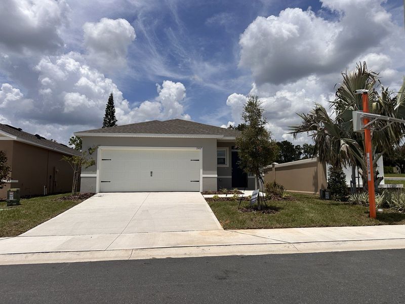 A charming single-story home with a spacious driveway in Cascades by D.R. Horton, located in Davenport, FL.