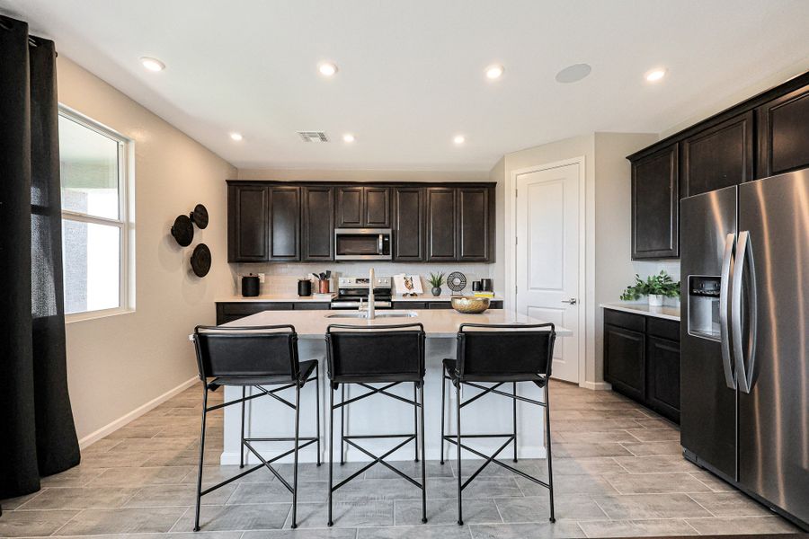A kitchen with black chairs. A kitchen with black chairs.