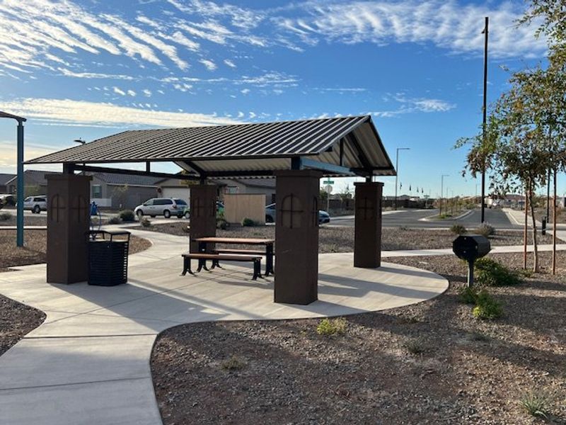 A modern park pavilion with seating and BBQ amenities in Canyon Views by Starlight Homes (Litchfield Park, AZ).