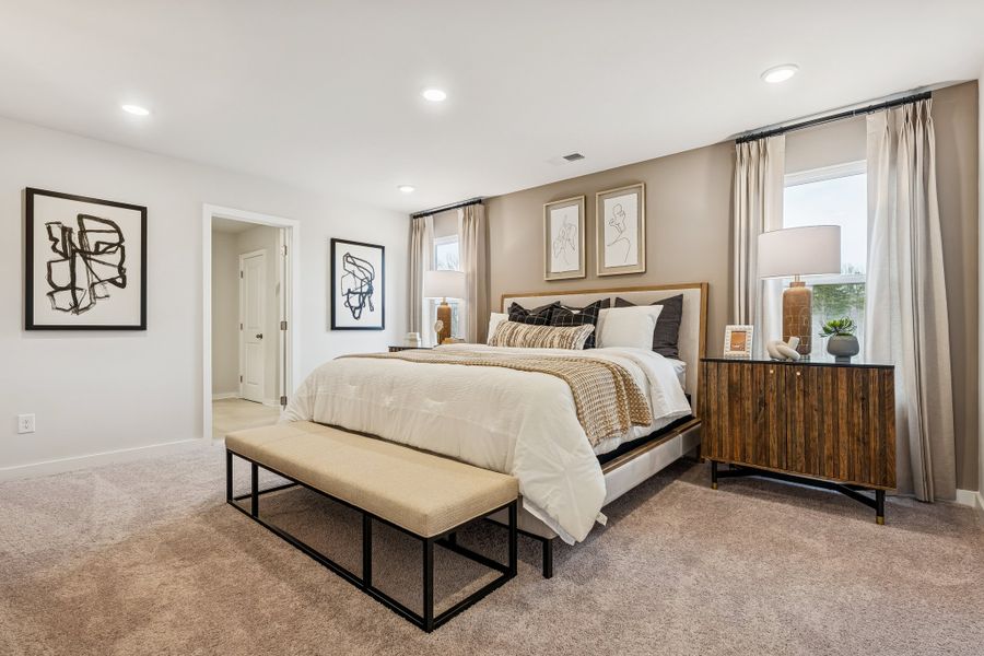 A bedroom with a bed and a bench. A bedroom with a bed and a bench.
