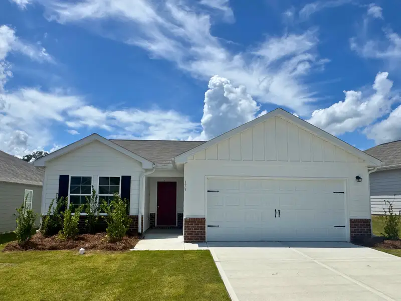 A white house with a garage.