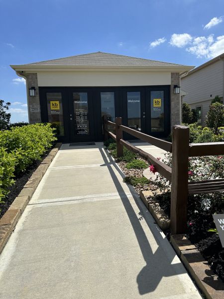 A welcoming modern entrance surrounded by lush landscaping in Bauer Meadow by KB Home (Hockley, TX).