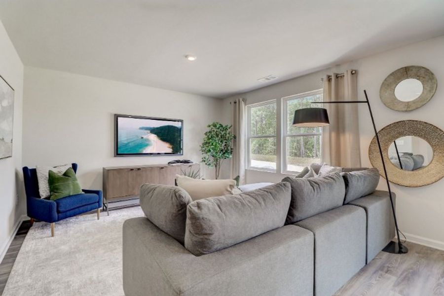 A living room with a couch and a tv.