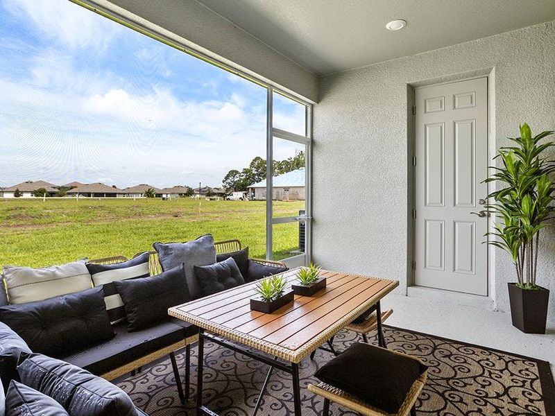 Your living space extends outdoors to a covered lanai - Waylyn model home in St. Cloud, FL