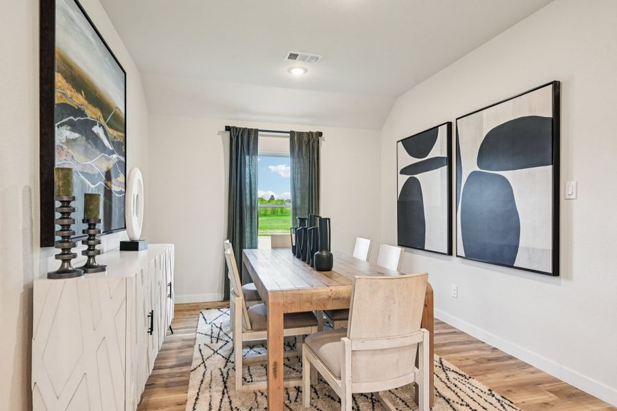 A dining room with a large window.