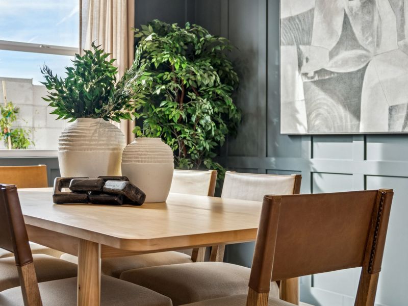 A table with chairs and a plant on it.