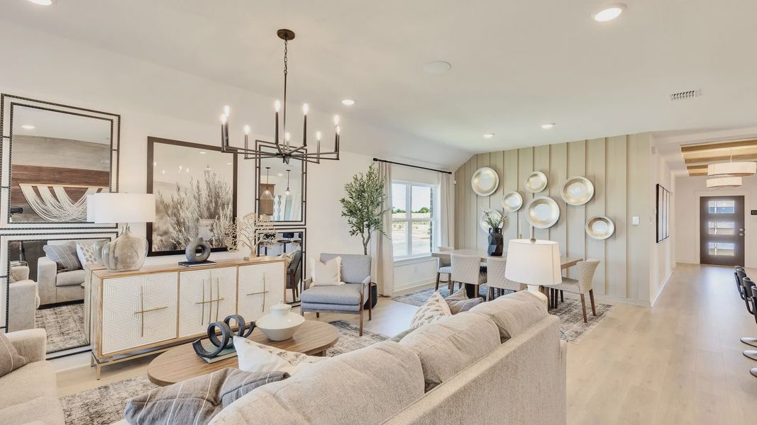 Hunter’s Glen living room boasts a chic chandelier, wood accents, and designer wall art. Hunter’s Glen living room boasts a chic chandelier, wood accents, and designer wall art.