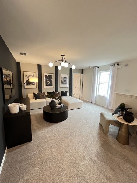 A chic living area with monochrome decor, modern art, cozy seating, and trendy lighting. A chic living area with monochrome decor, modern art, cozy seating, and trendy lighting.