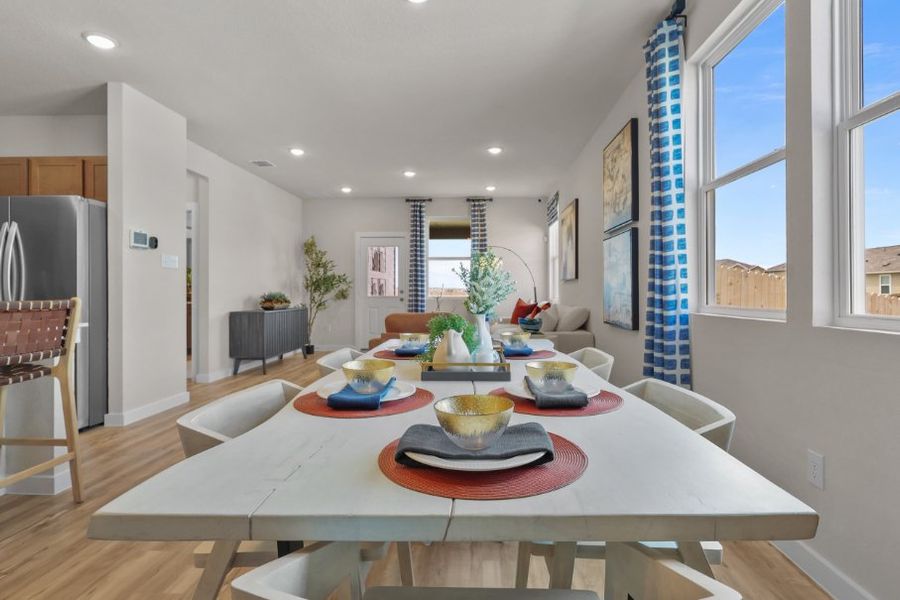 A dining room with a table and chairs.