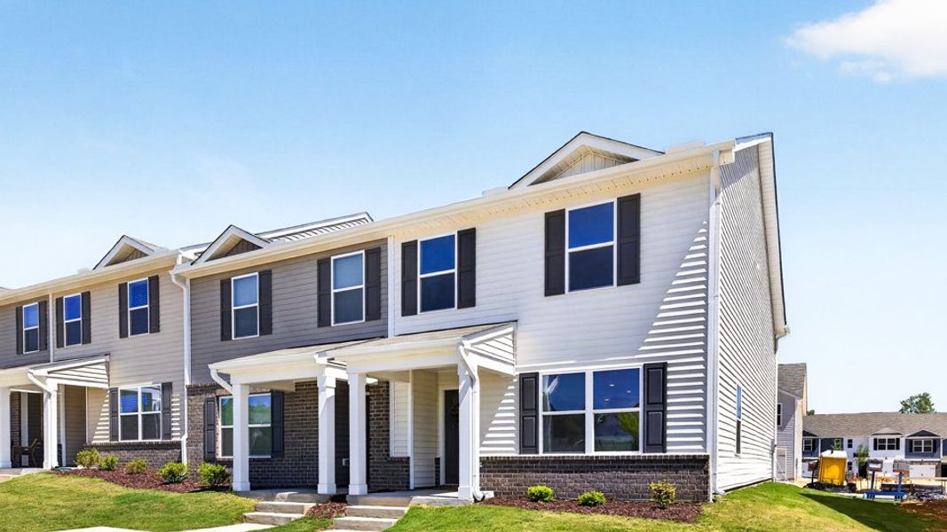 Front exterior of a home in the The Townes at Matthews Landing community, located in Fuquay Varina, NC (Image 4). Front exterior of a home in the The Townes at Matthews Landing community, located in Fuquay Varina, NC (Image 4).