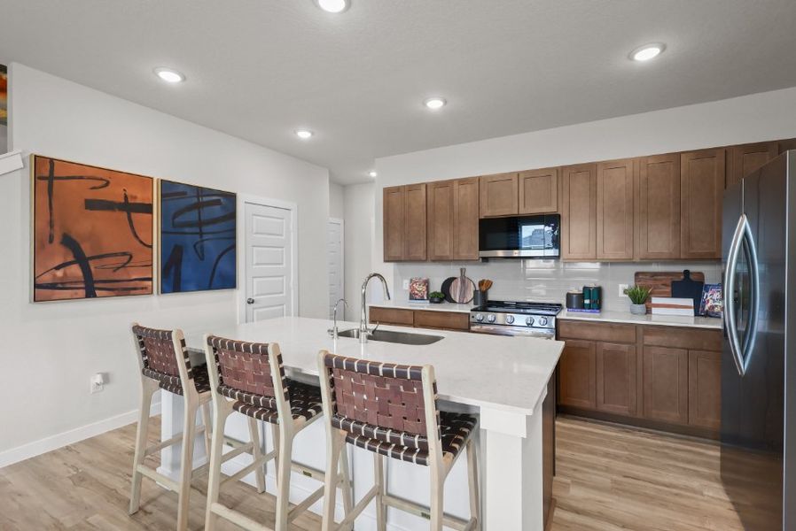 A kitchen with a table and chairs.