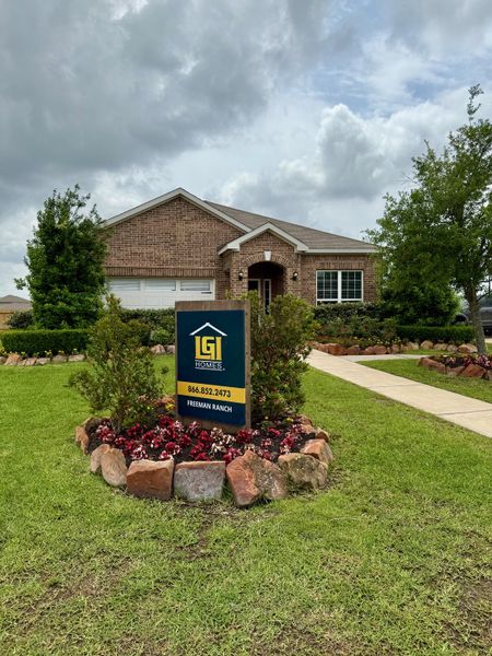 A charming brick home with a lush yard in Freeman Ranch by LGI Homes (Katy, TX).
