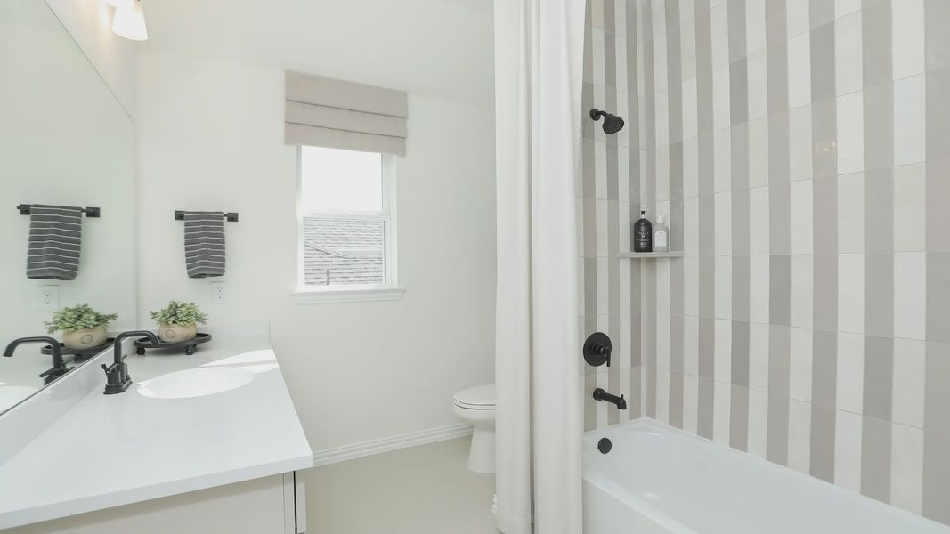 Luxurious Brookewater bathroom featuring sleek black fixtures and chic striped tiles, exuding modern elegance. Luxurious Brookewater bathroom featuring sleek black fixtures and chic striped tiles, exuding modern elegance.