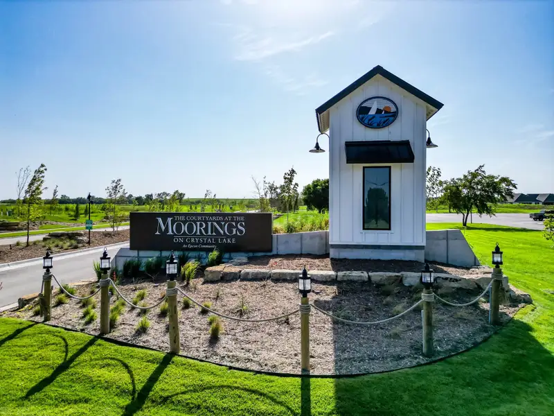 Entrance to the The Courtyards at The Moorings community in Wichita, KS, featuring signage and landscaping (Image 2).