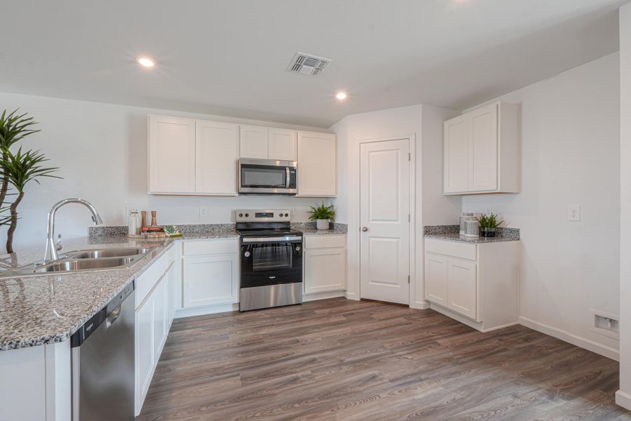 A kitchen with white cabinets. A kitchen with white cabinets.