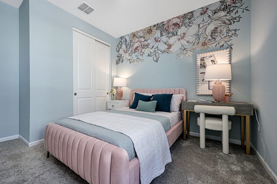A bedroom with a bed and a desk. A bedroom with a bed and a desk.