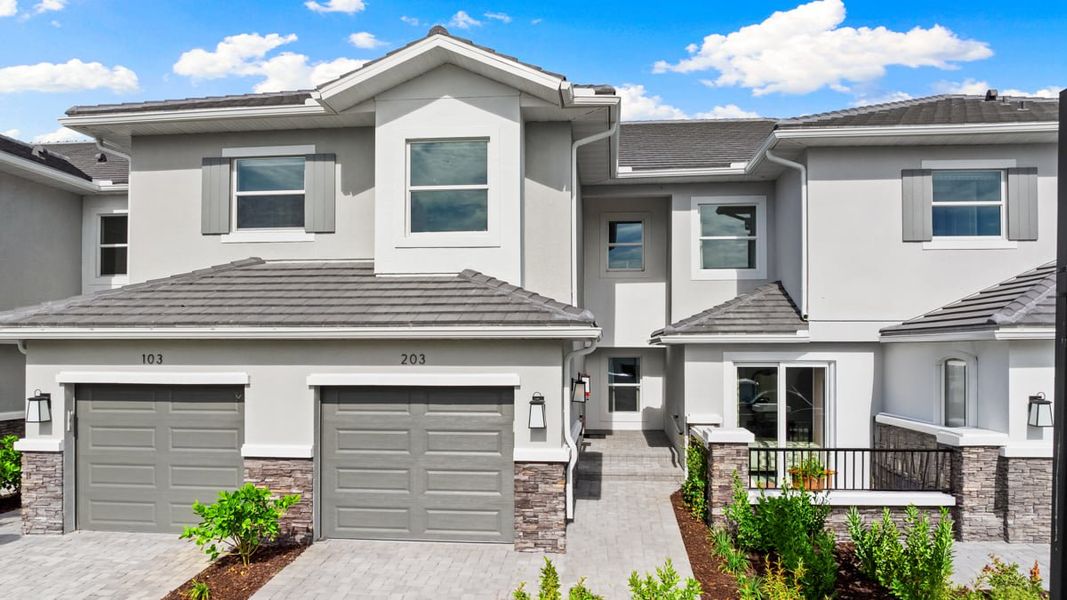 Front exterior of a home in the Esplanade by the Islands Coach Homes community, located in Naples, FL (Image 21).