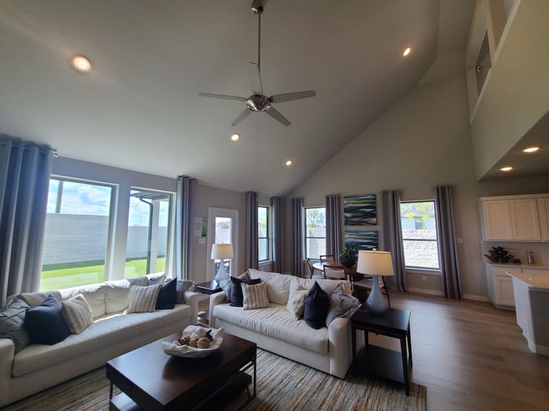 A spacious living room with high ceilings, natural light, cozy sofas, and modern decor creates an inviting atmosphere. A spacious living room with high ceilings, natural light, cozy sofas, and modern decor creates an inviting atmosphere.