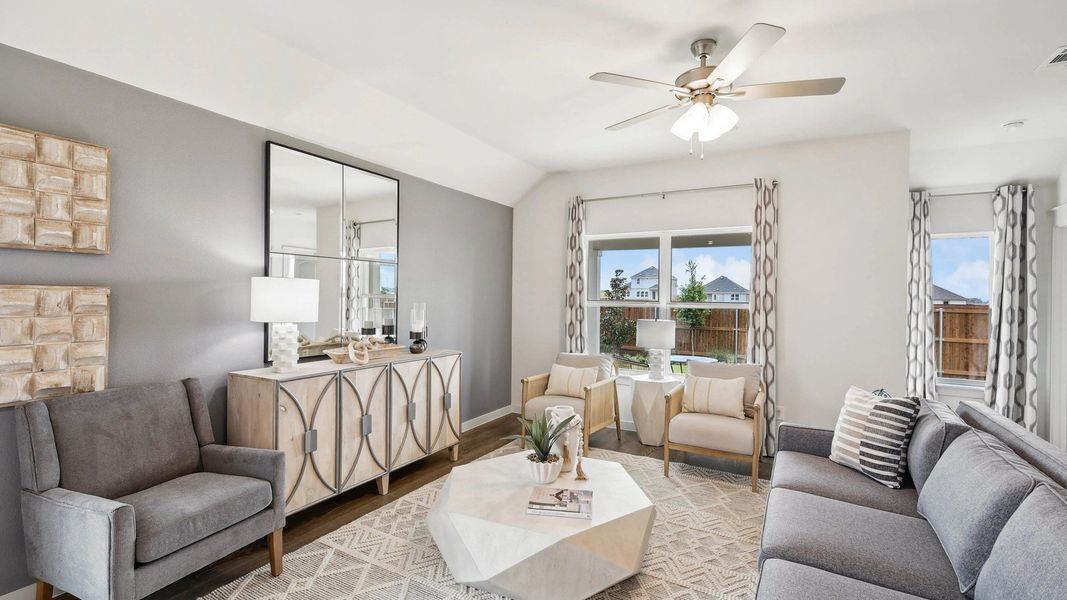 Featuring geometric accents, oversized windows, and plush seating in Still Water Lake Estates.