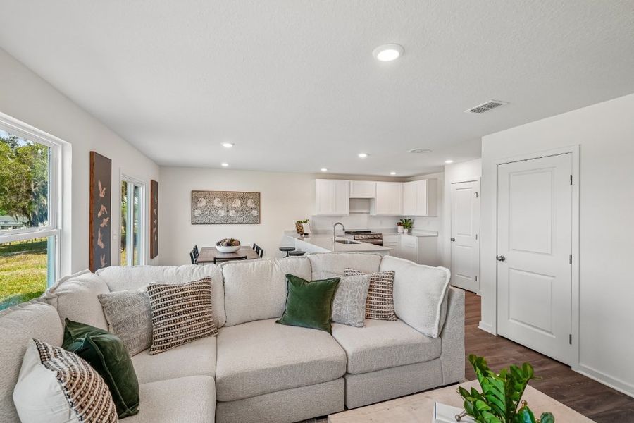 A living room with a couch and a table. A living room with a couch and a table.