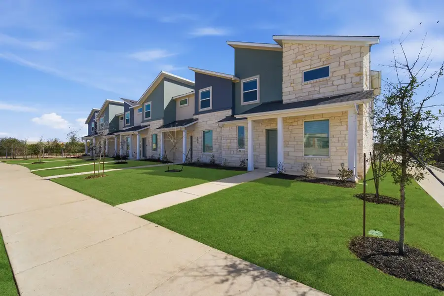 Front exterior of a home in the Municipal Drive Townhomes community, located in Leander, TX (Image 6).