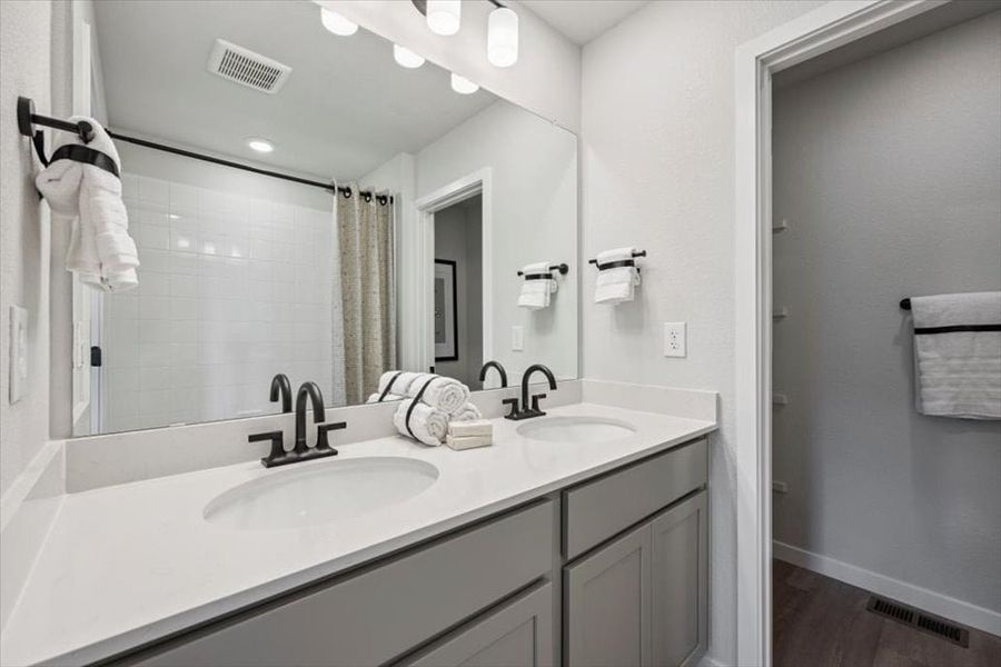 A bathroom with a large mirror.