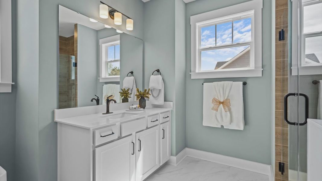Luxe neutral primary bathroom in two story home in Woodruff, SC at Pinebrook by DRB Homes Luxe neutral primary bathroom in two story home in Woodruff, SC at Pinebrook by DRB Homes