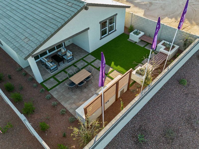 A small backyard with a patio and a swimming pool.