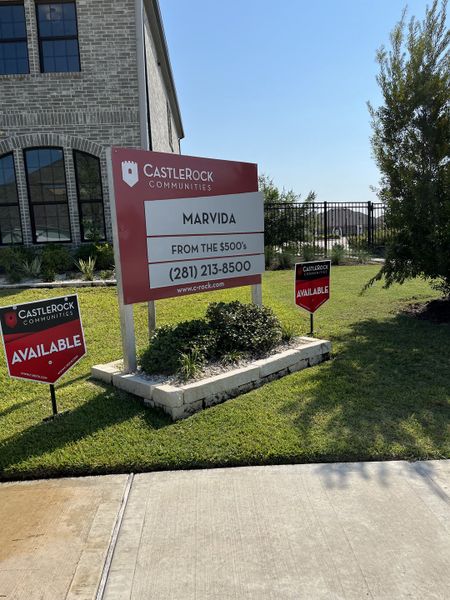 Modern brick home with lush landscaping at Marvida by CastleRock Communities in Cypress, TX.