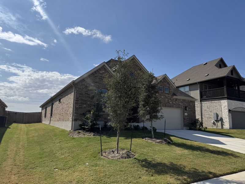 A charming brick home with lush greenery in Highlands North by Brightland Homes (Hutto, TX). A charming brick home with lush greenery in Highlands North by Brightland Homes (Hutto, TX).