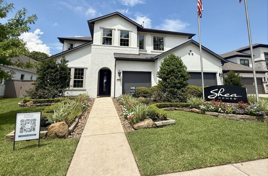 A beautiful white brick home with manicured landscaping in Sienna 65' by Shea Homes, Missouri City, TX.